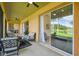 Covered patio with lake views and a large sliding glass door at 517 Milano Rd, Poinciana, FL 34759
