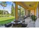 Screened-in patio with a fire pit overlooking the backyard and lake at 517 Milano Rd, Poinciana, FL 34759