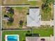 Top-down aerial view of a home with a backyard pool and an expansive, fenced-in yard at 6006 Country Walk Ln, Winter Haven, FL 33880