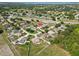 High aerial perspective of a residential area with established homes and lush green spaces at 6006 Country Walk Ln, Winter Haven, FL 33880