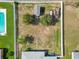 Aerial shot of a spacious, fenced-in backyard with a shed, trees, and ample green space at 6006 Country Walk Ln, Winter Haven, FL 33880