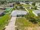 Back aerial view of home with big backyard, white fence, shed, and neighboring pool at 6006 Country Walk Ln, Winter Haven, FL 33880