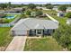 Aerial view of the home with a new gray roof, updated landscaping, and an attached two car garage at 6006 Country Walk Ln, Winter Haven, FL 33880