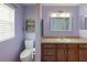 Neutral bathroom featuring a toilet, large mirror and vanity area with sink at 6006 Country Walk Ln, Winter Haven, FL 33880