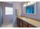 Neutral bathroom featuring a large mirror and vanity area with sink and towel rack at 6006 Country Walk Ln, Winter Haven, FL 33880