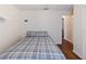 Cozy bedroom showcasing dark hardwood floors, a comfortable bed, neutral walls and bright natural light at 6006 Country Walk Ln, Winter Haven, FL 33880