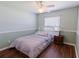 Cozy bedroom with a comfortable bed, ceiling fan, and window offering natural light at 6006 Country Walk Ln, Winter Haven, FL 33880