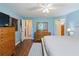 Bright blue bedroom features wood floors, a bed with bench, and connecting doors to other rooms at 6006 Country Walk Ln, Winter Haven, FL 33880