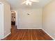 Neutral bedroom with wood floors features an adjacent doorway to another room at 6006 Country Walk Ln, Winter Haven, FL 33880