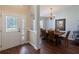 Traditional dining room featuring wood floors, table with chairs and an elegant chandelier at 6006 Country Walk Ln, Winter Haven, FL 33880
