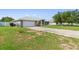 Charming single-story home with a two-car garage and a well-manicured front lawn at 6006 Country Walk Ln, Winter Haven, FL 33880