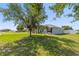 Front exterior of home with large shade tree at 6006 Country Walk Ln, Winter Haven, FL 33880