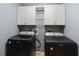 Laundry area with upper storage features a black Maytag washer and dryer at 6006 Country Walk Ln, Winter Haven, FL 33880