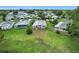 Scenic aerial view of a community with well-maintained homes and a lush green landscape at 6044 Grand Oaks Se Dr, Winter Haven, FL 33884