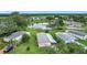 Beautiful aerial view of a charming community with pond, mature landscaping, and well-maintained homes at 6044 Grand Oaks Se Dr, Winter Haven, FL 33884