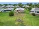Expansive backyard featuring lush lawn and seating area, perfect for relaxation and enjoying the outdoors at 6044 Grand Oaks Se Dr, Winter Haven, FL 33884