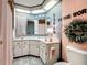 Bright bathroom with a corner sink and artistic decor for a cheerful ambiance at 6044 Grand Oaks Se Dr, Winter Haven, FL 33884