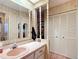 Bathroom vanity with ample storage, mirrors and decorative molding at 6044 Grand Oaks Se Dr, Winter Haven, FL 33884