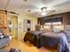 Bedroom featuring two twin beds with dark bedding, and a barn door closet at 6044 Grand Oaks Se Dr, Winter Haven, FL 33884