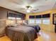 Bedroom featuring two twin beds with dark bedding and multiple windows at 6044 Grand Oaks Se Dr, Winter Haven, FL 33884