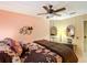 Bedroom featuring a floral bedspread, multiple mirrors, and accent wall decor at 6044 Grand Oaks Se Dr, Winter Haven, FL 33884