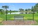 A serene community pond featuring a fountain and bench seating for relaxation at 6044 Grand Oaks Se Dr, Winter Haven, FL 33884