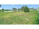 Scenic view of community green space with a pond and fountain at 6044 Grand Oaks Se Dr, Winter Haven, FL 33884
