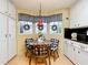 Eat-in dining area with windows, red pendant light, and wood table and chairs at 6044 Grand Oaks Se Dr, Winter Haven, FL 33884