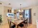 Dining room with a wooden table, chandelier, and decorative buffalo check accents at 6044 Grand Oaks Se Dr, Winter Haven, FL 33884
