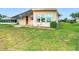 Well-maintained home with tidy garden beds and covered patio at 6044 Grand Oaks Se Dr, Winter Haven, FL 33884
