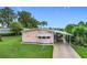 Charming home with well-manicured lawn and covered driveway at 6044 Grand Oaks Se Dr, Winter Haven, FL 33884