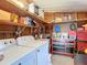 Organized garage area with laundry machines, storage shelves, and a tool chest at 6044 Grand Oaks Se Dr, Winter Haven, FL 33884