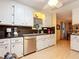 Bright kitchen featuring white cabinets, black countertops, and modern stainless steel appliances at 6044 Grand Oaks Se Dr, Winter Haven, FL 33884