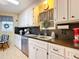 Cozy kitchen with white cabinets, stainless steel appliances, and black countertops at 6044 Grand Oaks Se Dr, Winter Haven, FL 33884