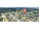 Aerial view of neighborhood with houses surrounded by trees and lush landscape at 647 Washington Way, Haines City, FL 33844