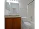 A well-lit full bathroom featuring a granite countertop, wood cabinets, and a shower-tub combo at 647 Washington Way, Haines City, FL 33844