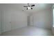 This bedroom features neutral walls, tile floors, and a ceiling fan for added comfort at 647 Washington Way, Haines City, FL 33844