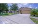A lovely single-Gathering home with a well-kept lawn and a wide driveway leading to an attached two-car garage at 647 Washington Way, Haines City, FL 33844