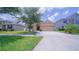 Inviting single-story home with a manicured lawn, lovely landscaping, and a welcoming front entrance at 647 Washington Way, Haines City, FL 33844