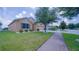Charming single-story home featuring a well-manicured lawn, inviting curb appeal, and mature landscaping at 647 Washington Way, Haines City, FL 33844