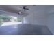 Spacious garage offering ample parking and storage, with an open door view to the street at 647 Washington Way, Haines City, FL 33844