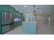 Bright kitchen boasts stainless steel appliances, custom cabinets, kitchen island, and modern pendant lighting at 647 Washington Way, Haines City, FL 33844