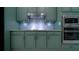 Well-appointed kitchen with custom cabinetry, a stylish backsplash, and stainless steel appliances for modern living at 647 Washington Way, Haines City, FL 33844