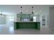 Open-concept kitchen with stylish green cabinets, stainless steel appliances, and a large center island at 647 Washington Way, Haines City, FL 33844