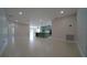 Open-concept living room and kitchen with tile floors and recessed lighting at 647 Washington Way, Haines City, FL 33844