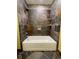 Bathroom featuring a white tub surrounded by decorative earth-toned ceramic tiles at 7200 Green Pine Ct, Orlando, FL 32819