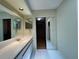 Bright bathroom with neutral walls, vanity, and walk-in closet at 7200 Green Pine Ct, Orlando, FL 32819