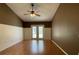 Bedroom features a ceiling fan and hardwood floors; French doors lead to a patio at 7200 Green Pine Ct, Orlando, FL 32819