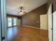 Bedroom featuring hardwood floors, ceiling fan, and a double door entry to the backyard at 7200 Green Pine Ct, Orlando, FL 32819