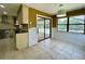 Bright breakfast nook with tile flooring, sliding glass doors to the screened lanai, and black granite countertops at 7200 Green Pine Ct, Orlando, FL 32819